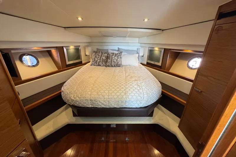 Slide: The Image of Luxurious bedroom interior of 2016 Tiara Yachts C44 Coupe with elegant bedding and wood accents. - 51