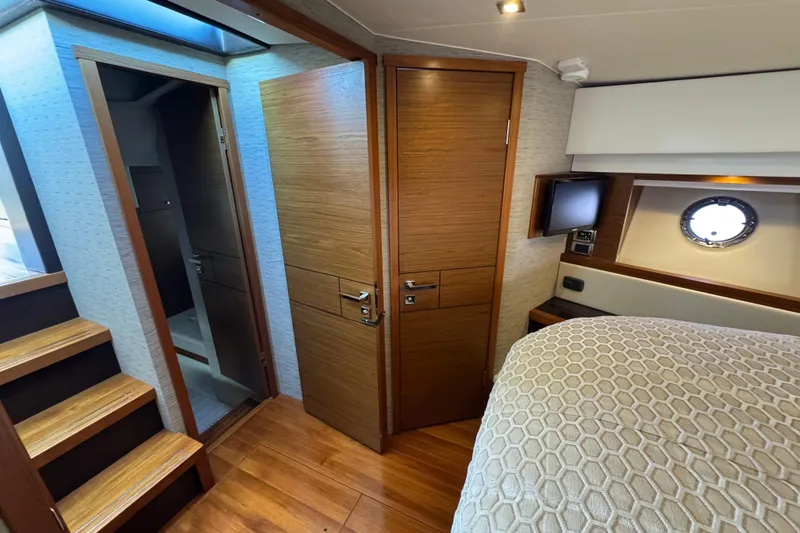 Slide: The Image of Interior of 2016 Tiara Yachts C44 Coupe, featuring wood finishes and modern design. - 53