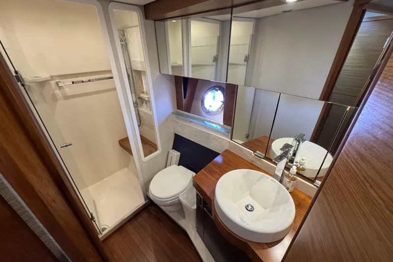 Slide: The Image of Luxurious bathroom in 2016 Tiara Yachts C44 Coupe with modern fixtures and wood accents. - 54