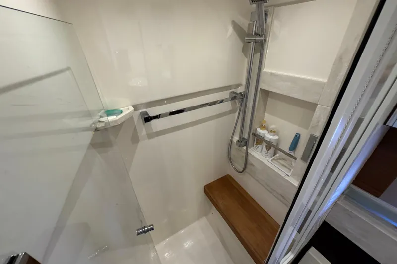 Slide: The Image of Luxurious shower area in 2016 Tiara Yachts C44 Coupe with modern fixtures and wooden bench. - 55