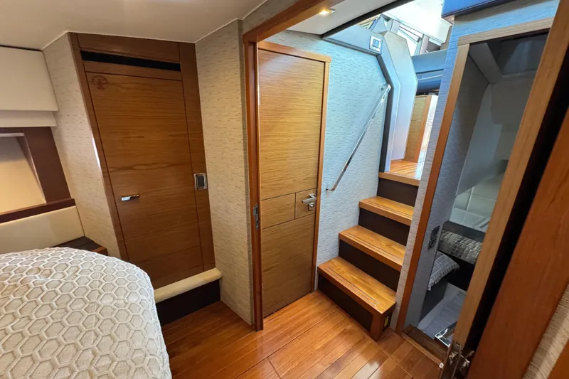 Slide: The Image of 2016 Tiara Yachts C44 Coupe interior with wooden stairs and modern cabin design. - 56