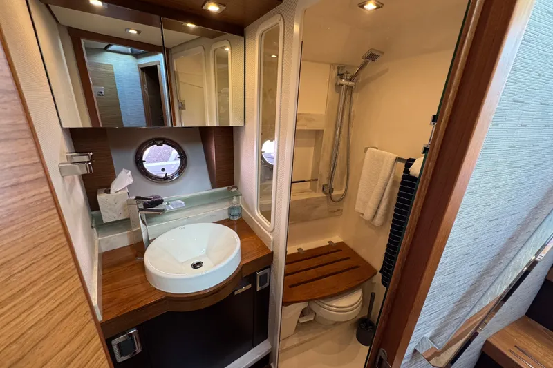 Slide: The Image of Luxurious 2016 Tiara Yachts C44 Coupe bathroom with modern fixtures and elegant wood accents. - 57