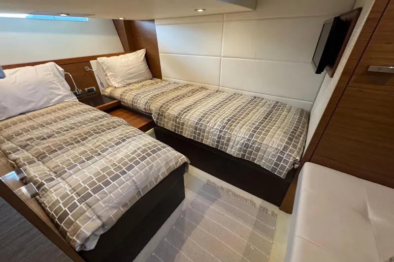Slide: The Image of 2016 Tiara Yachts C44 Coupe cabin with twin beds and modern decor. - 59