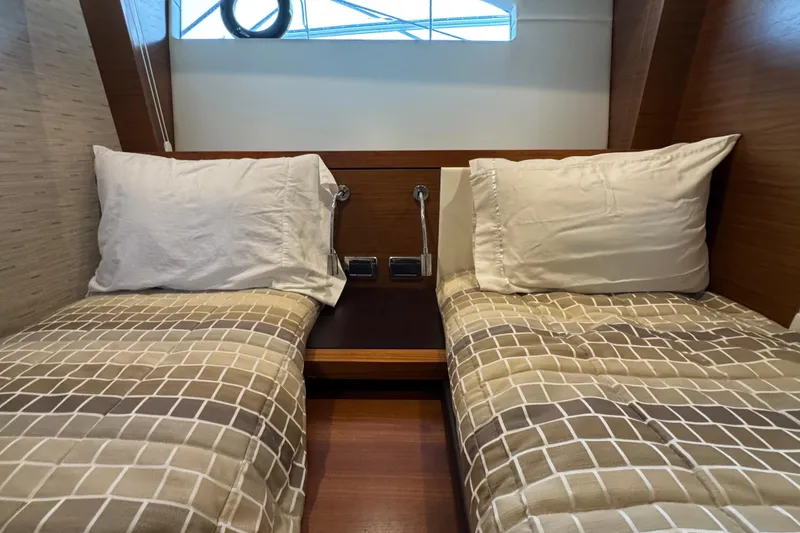 Slide: The Image of Cabin interior of 2016 Tiara Yachts C44 Coupe with twin beds and modern decor. - 62