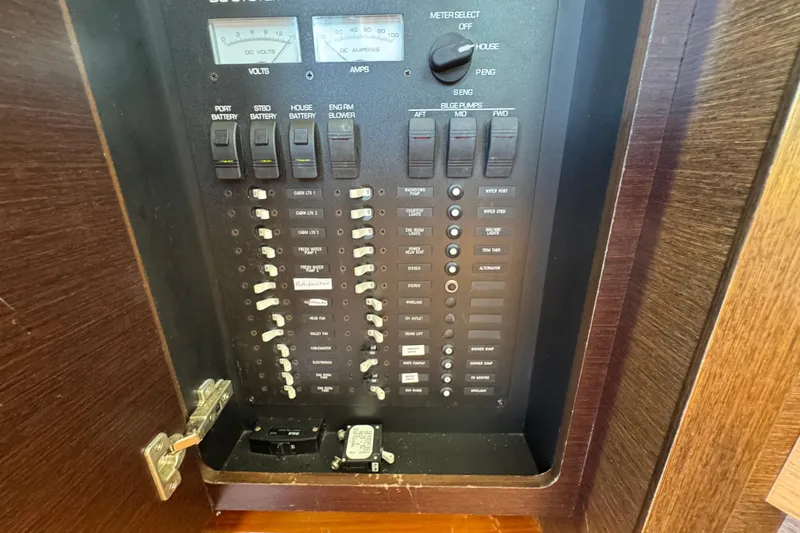 Slide: The Image of Electrical panel of a 2016 Tiara Yachts C44 Coupe, featuring switches and meters. - 64