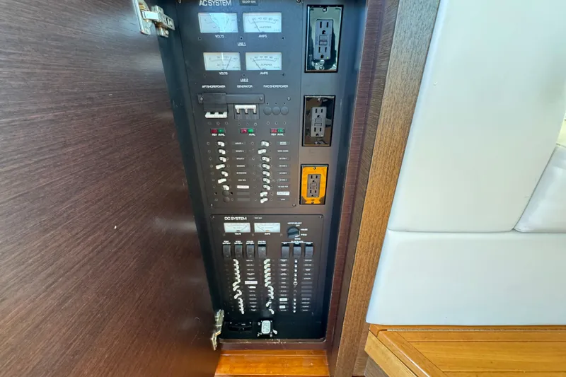 Slide: The Image of Electrical panel of 2016 Tiara Yachts C44 Coupe, featuring AC and DC systems. - 66