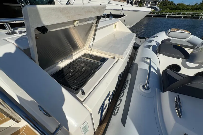 Slide: The Image of Outdoor grill on 2016 Tiara Yachts C44 Coupe, docked beside an inflatable boat. - 67