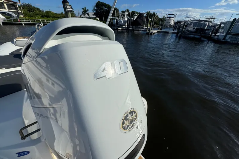 Slide: The Image of Outboard motor on a 2016 Tiara Yachts C44 Coupe, docked at a marina. - 69