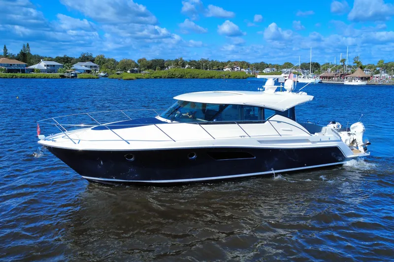 Slide: The Image of 2016 Tiara Yachts C44 Coupe cruising on a sunny day with blue skies. - 7