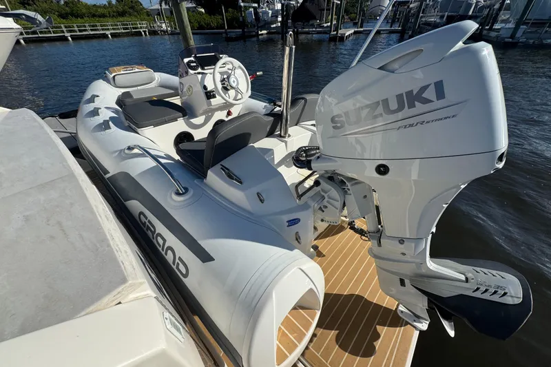 Slide: The Image of Inflatable boat with Suzuki outboard motor docked beside Tiara Yachts C44 Coupe, 2016 model. - 70