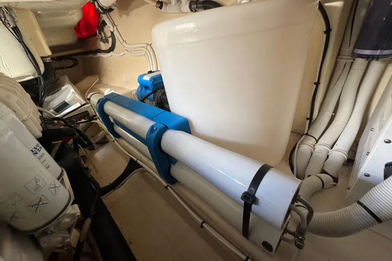 Slide: The Image of Engine room of 2016 Tiara Yachts C44 Coupe, showcasing mechanical components and piping. - 71