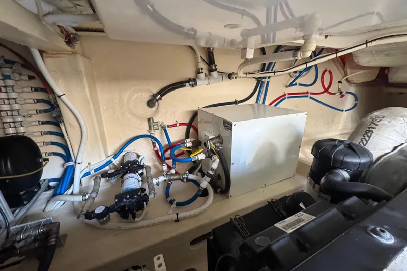 Slide: The Image of Engine room of 2016 Tiara Yachts C44 Coupe with visible wiring and equipment. - 79