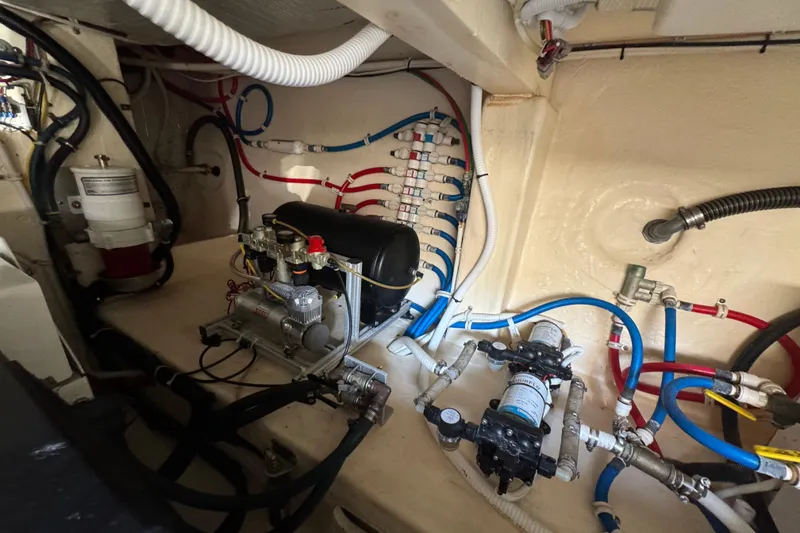 Slide: The Image of Engine room of 2016 Tiara Yachts C44 Coupe with complex wiring and machinery. - 80