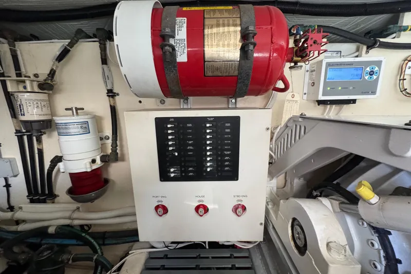 Slide: The Image of Engine room of 2016 Tiara Yachts C44 Coupe with control panel and fire extinguisher. - 83