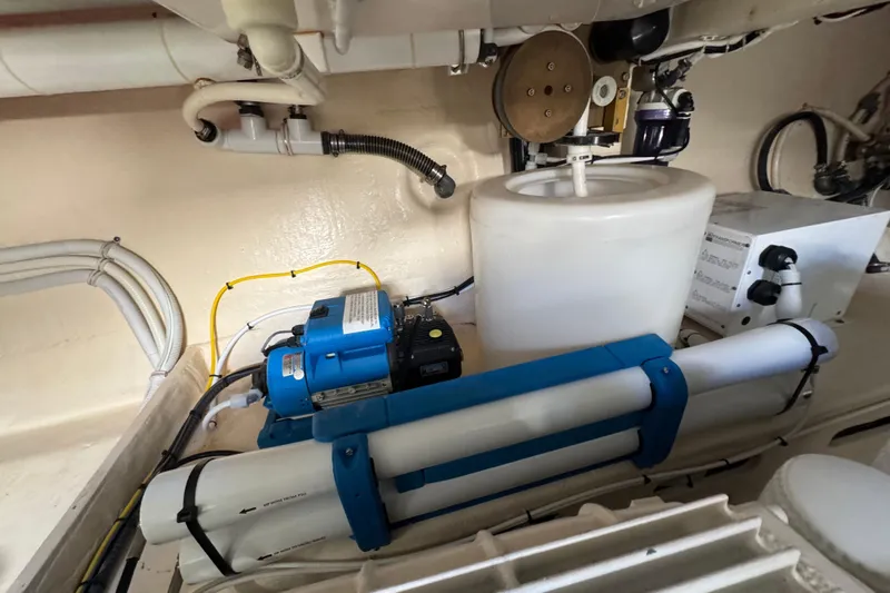 Slide: The Image of Engine room of 2016 Tiara Yachts C44 Coupe with mechanical equipment and piping. - 86