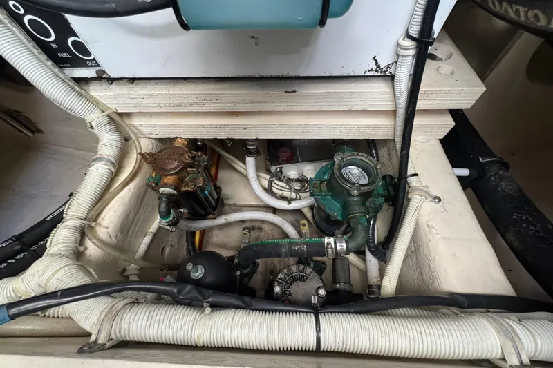 Slide: The Image of Engine compartment of a 2016 Tiara Yachts C44 Coupe, showcasing mechanical components and wiring. - 88