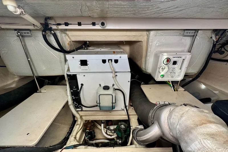 Slide: The Image of Engine room of 2016 Tiara Yachts C44 Coupe with mechanical equipment and wiring. - 89