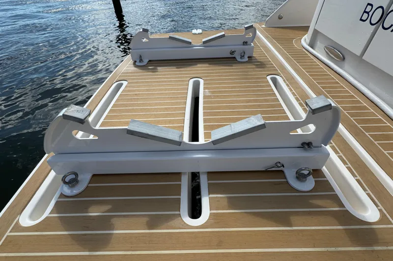 Slide: The Image of 2016 Tiara Yachts C44 Coupe swim platform with custom mounts, docked by the water. - 91