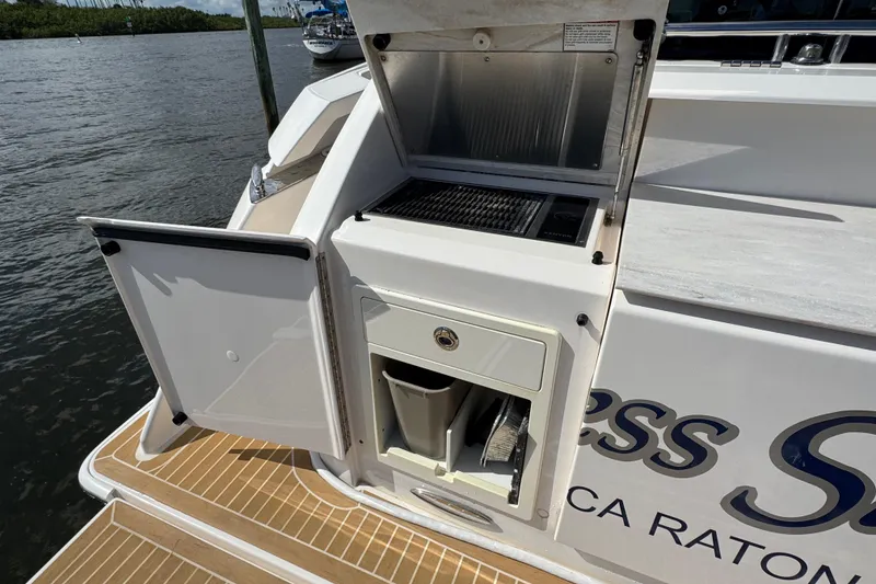 Slide: The Image of 2016 Tiara Yachts C44 Coupe outdoor kitchen with grill and storage. - 93