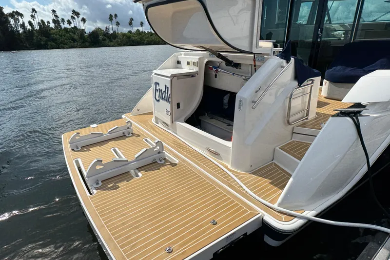 Slide: The Image of 2016 Tiara Yachts C44 Coupe with open storage, docked on calm water. - 96