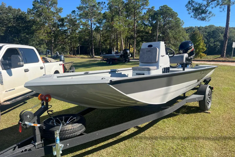 Slide: The Image of 2026 Avid 18 Rogue CC boat on trailer, parked on grass with trees in background. - 0