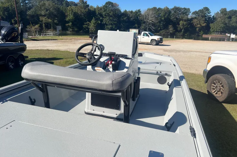 Slide: The Image of 2026 Avid 18 Rogue CC boat with steering console, parked outdoors. - 13