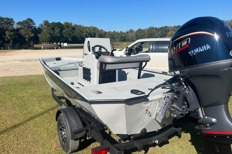 Slide: The Image of Avid 18 Rogue CC 2026 boat with Yamaha engine on trailer, parked outdoors. - 3