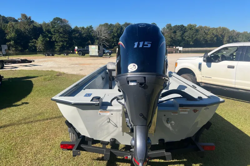 Slide: The Image of Avid 18 Rogue CC 2026 boat with 115 HP engine on trailer, parked outdoors. - 6