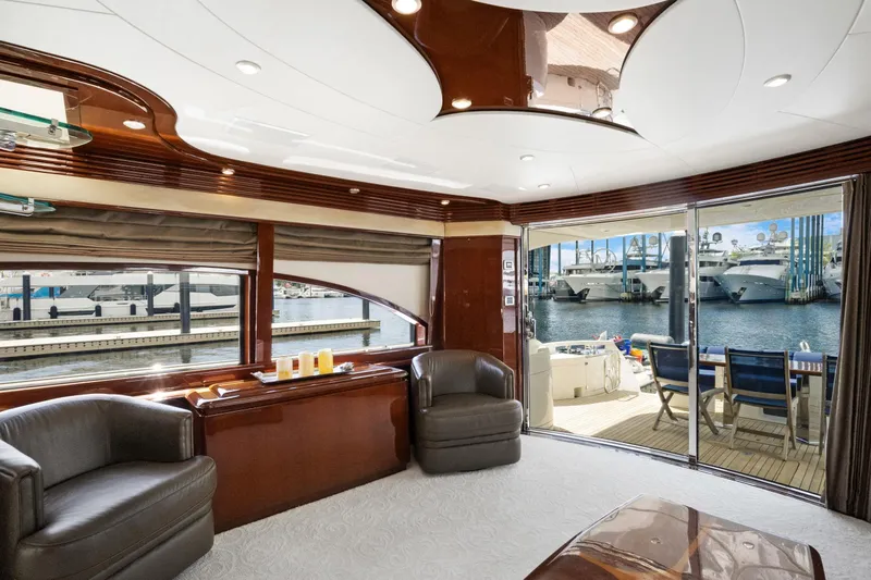 Slide: The Image of Luxurious 2008 Marquis 690 yacht interior with elegant seating and marina view. - 11