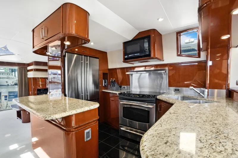 Slide: The Image of Luxurious kitchen interior of 2008 Marquis 690 yacht with modern appliances and granite countertops. - 13