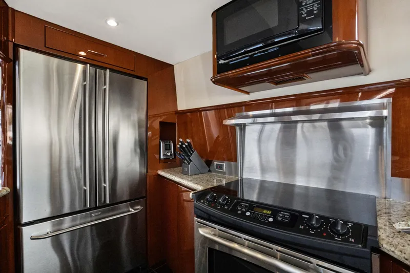 Slide: The Image of Luxurious kitchen in 2008 Marquis 690 yacht with stainless steel appliances and modern cabinetry. - 14