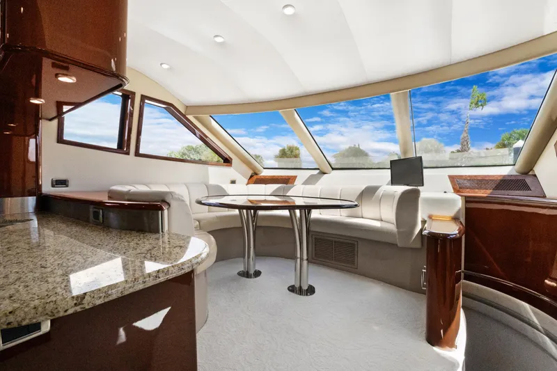 Slide: The Image of Luxurious 2008 Marquis 690 yacht interior with elegant seating and panoramic windows. - 18