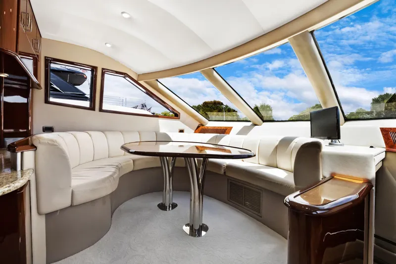 Slide: The Image of Luxurious interior of 2008 Marquis 690 yacht with elegant seating and panoramic windows. - 19