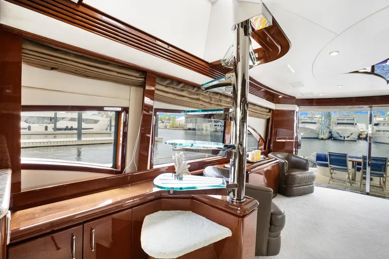 Slide: The Image of Luxurious interior of a 2008 Marquis 690 yacht with elegant seating and waterfront views. - 23