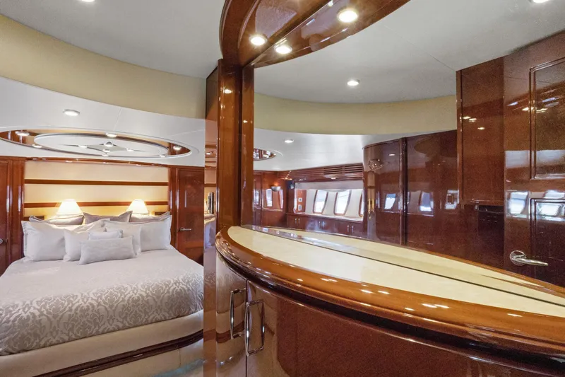 Slide: The Image of Luxurious interior of 2008 Marquis 690 yacht with elegant wood finishes and plush bedding. - 24
