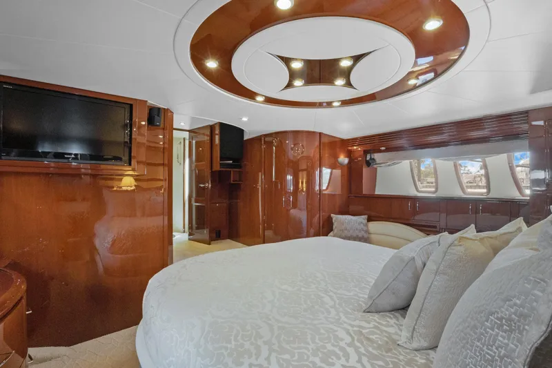 Slide: The Image of Luxurious 2008 Marquis 690 yacht bedroom with elegant wood finishes and modern amenities. - 28