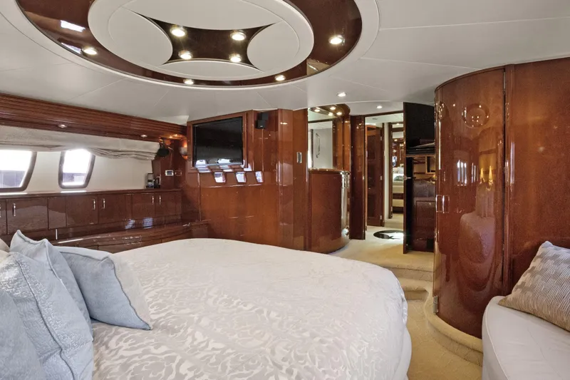Slide: The Image of Luxurious 2008 Marquis 690 yacht interior with elegant wood finishes and plush bedding. - 29