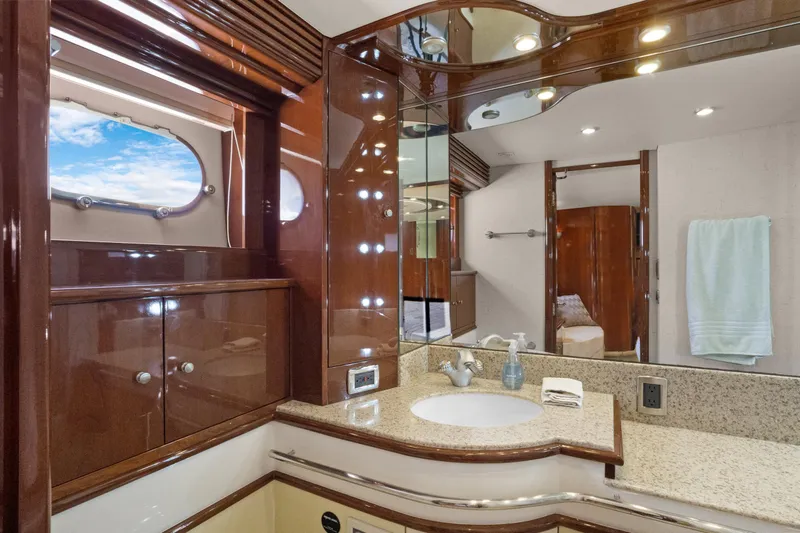 Slide: The Image of Luxurious 2008 Marquis 690 yacht bathroom with elegant wood finishes and granite countertop. - 31