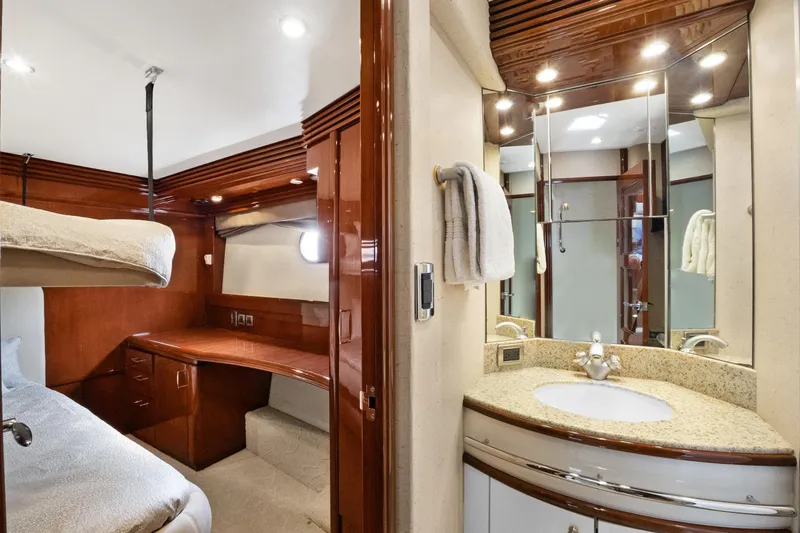 Slide: The Image of Luxurious 2008 Marquis 690 yacht interior with elegant wood finishes and modern bathroom. - 33