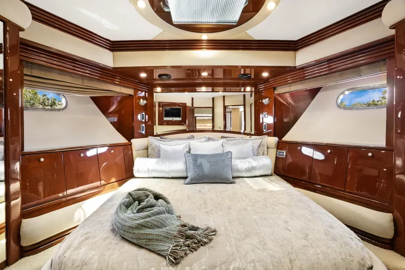 Slide: The Image of Luxurious 2008 Marquis 690 yacht bedroom with elegant wood finishes and plush bedding. - 34