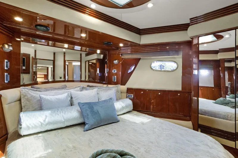 Slide: The Image of Luxurious 2008 Marquis 690 yacht bedroom with elegant wood finishes and plush bedding. - 35