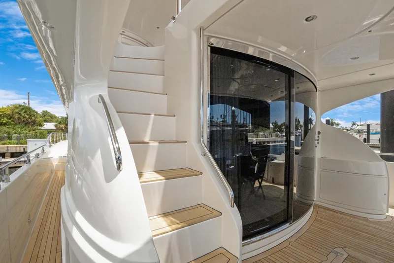 Slide: The Image of Luxurious 2008 Marquis 690 yacht with elegant staircase and sleek glass doors. - 4