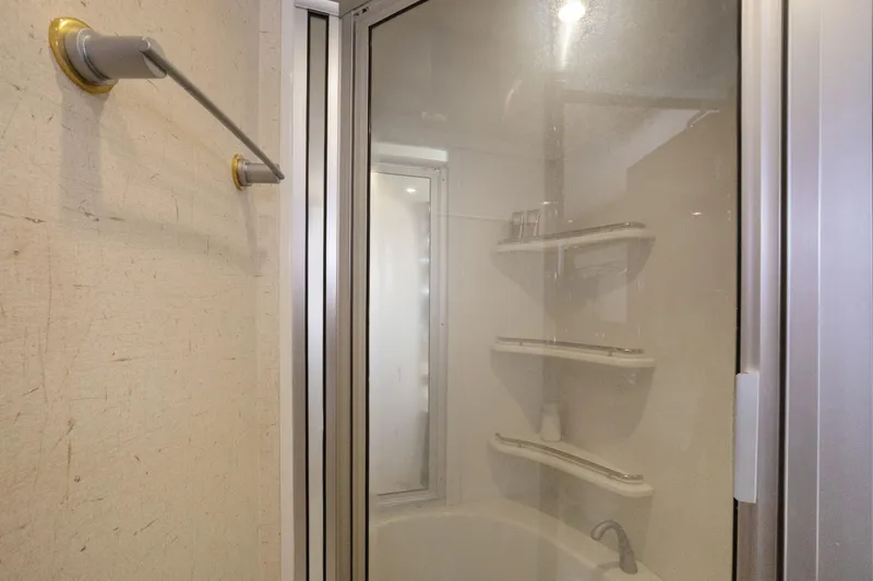 Slide: The Image of Shower area in 2008 Marquis 690 with glass door and corner shelves. - 40