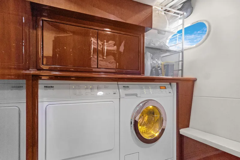 Slide: The Image of Laundry area in 2008 Marquis 690 yacht with Miele appliances and wooden cabinetry. - 41