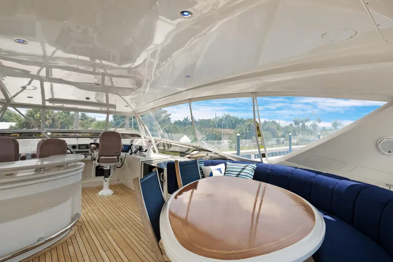 Slide: The Image of Luxurious 2008 Marquis 690 yacht interior with elegant seating and helm, featuring scenic views. - 42