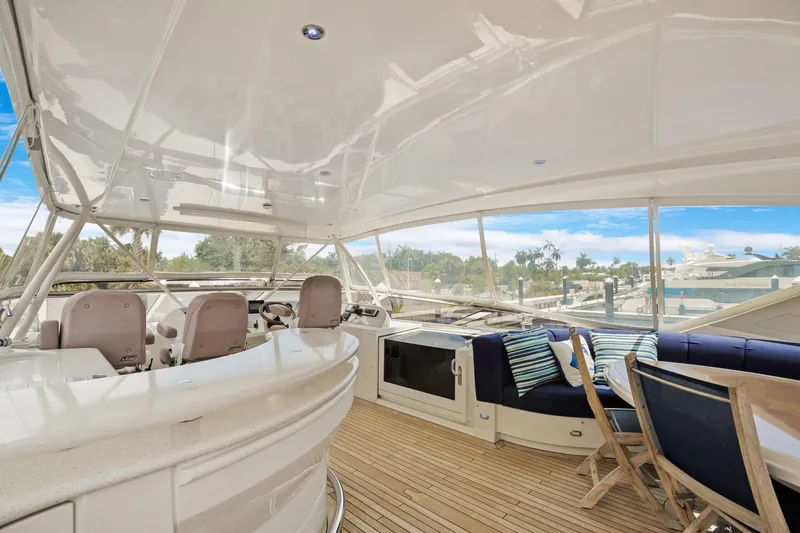 Slide: The Image of Luxurious 2008 Marquis 690 yacht interior with seating, helm, and scenic marina view. - 43