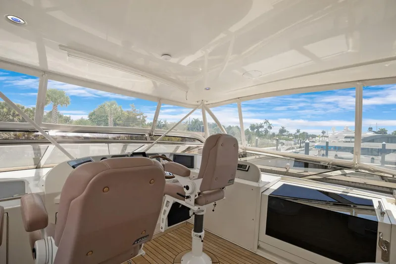 Slide: The Image of Interior view of 2008 Marquis 690 yacht cockpit with panoramic windows and captain's chairs. - 50