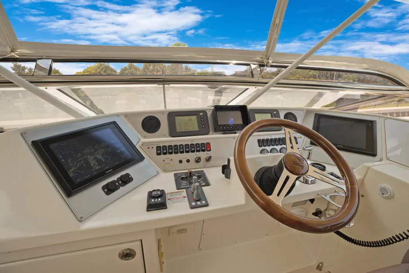 Slide: The Image of Cockpit of 2008 Marquis 690 yacht with navigation screens and steering wheel. - 52