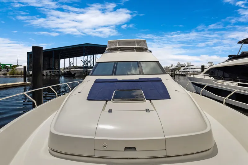Slide: The Image of Luxury 2008 Marquis 690 yacht docked under a clear blue sky. - 53