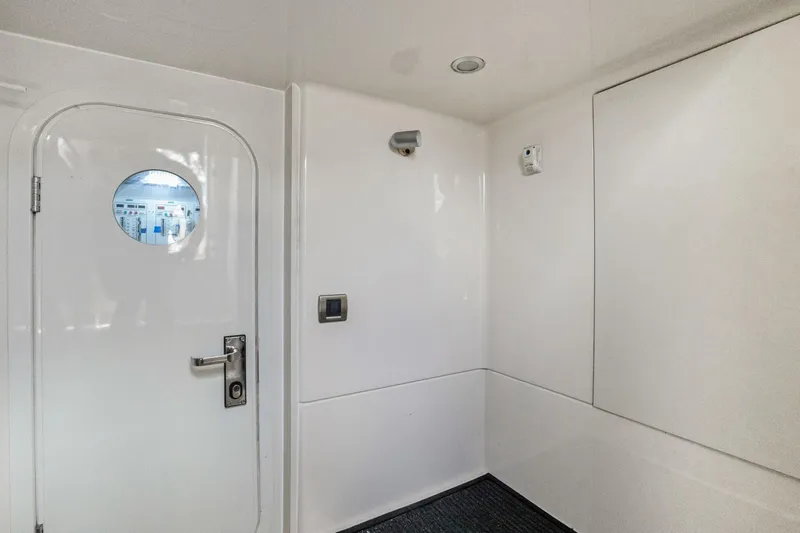 Slide: The Image of White interior of 2008 Marquis 690 yacht with round window and modern fixtures. - 56